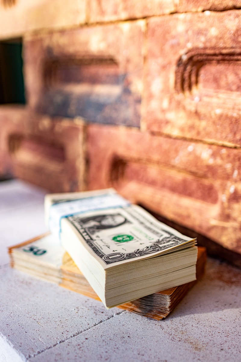 a stack of money sitting on top of a table symbolizing homeowners insurance rate increasing